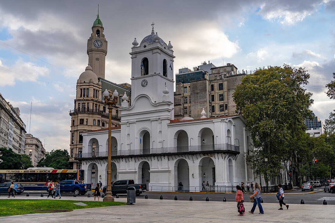 Cabildo with the clock tower of the Legislative Palace of the Autonomous City of Buenos Aires, Argentina behind. The Cabildo was the town hall or seat of government in colonial times.