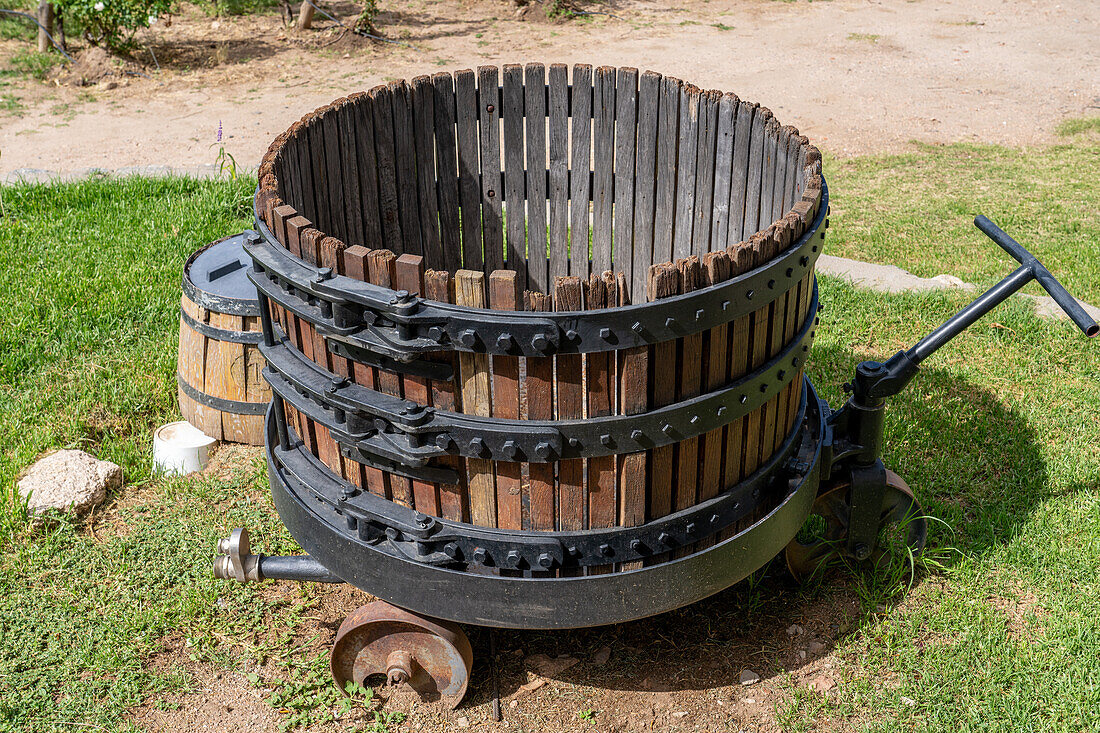 An old vintage wooden wine press at the Bodega and Finca las Nubes, a winery and vineyard near Cafayate, Argentina.