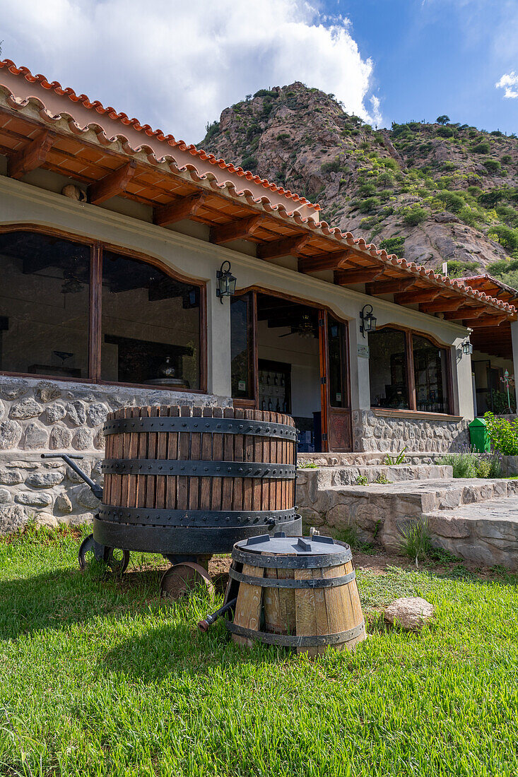 An old vintage wooden wine press at the Bodega and Finca las Nubes, a winery and vineyard near Cafayate, Argentina.