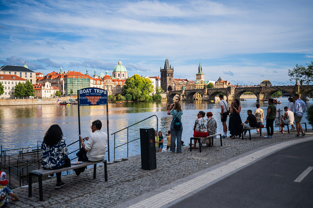 People enjoying themselves on the Vltava river bank, Prague