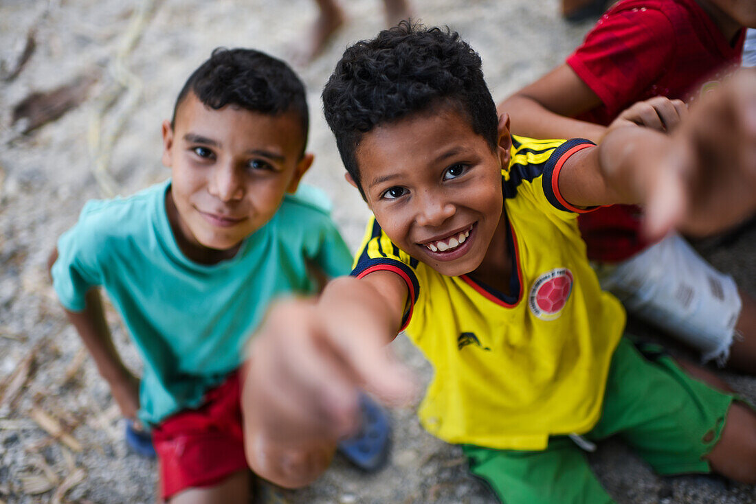 Group of playful local kids having fun with a foreigner woman, Santa Marta, Colombia