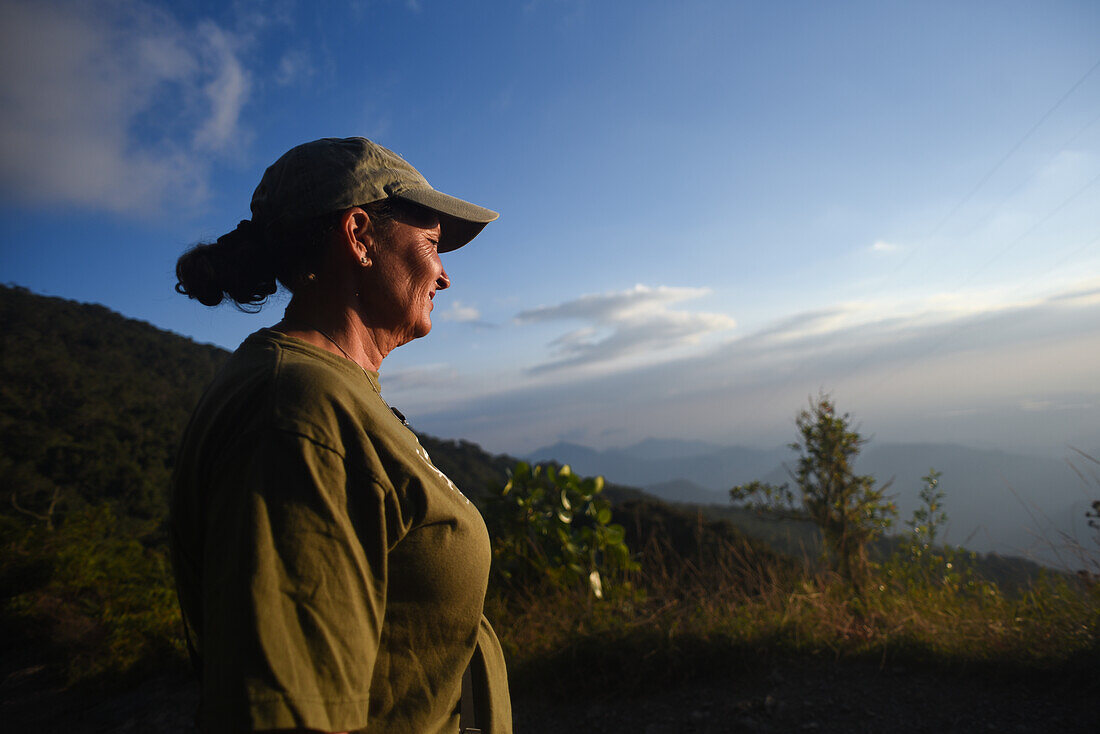 Woman enjoying a beautiful sunset in Sierra Nevada de Santa Marta, Colombia