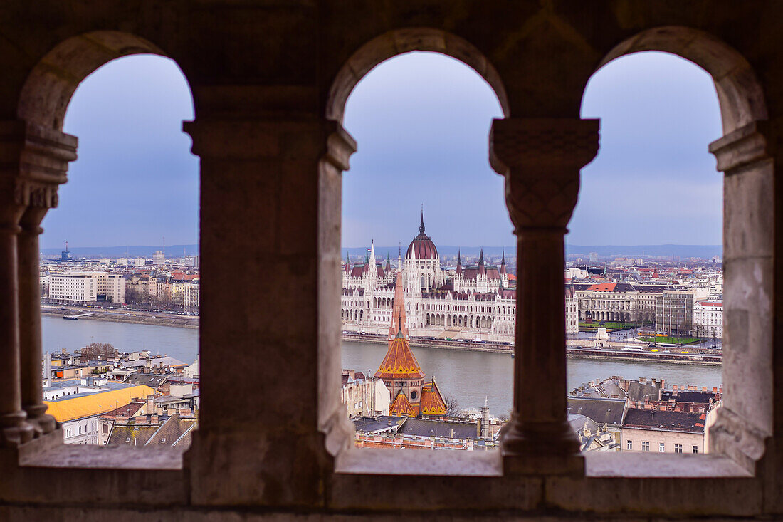 View of Parliament building, Chain Bridge and Danube River through old columns, Budapest, Hungary, Europe