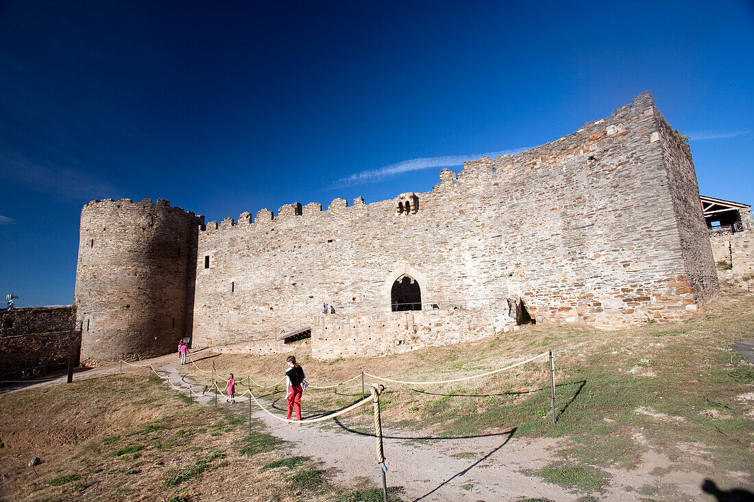 Visitors explore Castillo Viejo, part of the historic Templar castle in Ponferrada, showcasing medieval architecture and history.