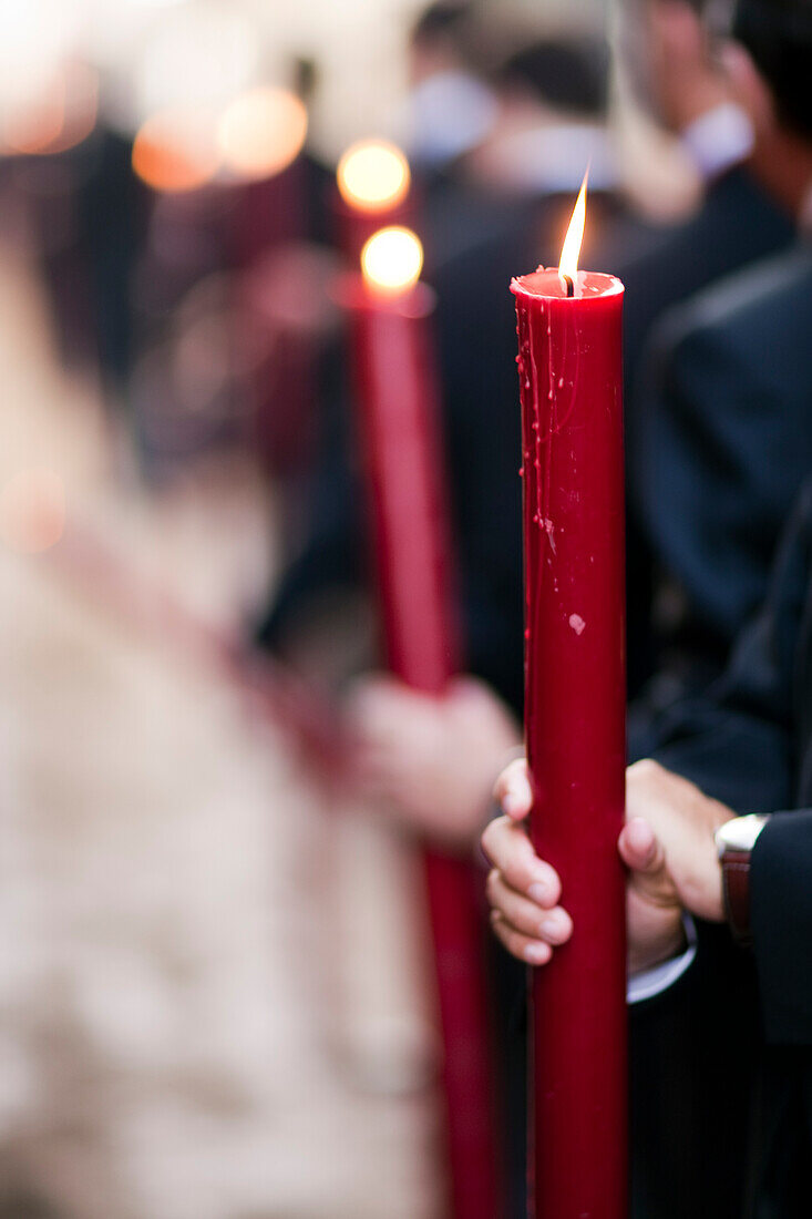 Members of a religious brotherhood hold candles while participating in the Corpus Christi procession in Seville, Spain, in 2009.