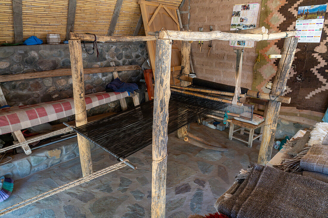 A wooden foot loom in a home weaving workshop in Seclantas, Argentina in the Calchaqui Valley.