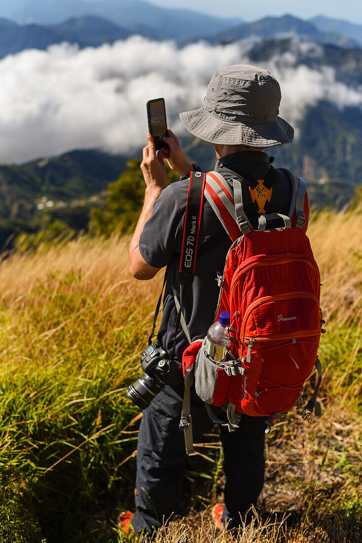 Hiker using his smartphone in the mountains of Sierra Nevada de Santa Marta, Colombia