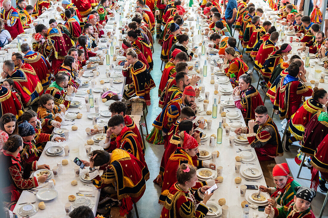 Traditionelles Mittagessen beim Fest des Heiligen Johannes von Sobrado, auch bekannt als Bugiada und Mouriscada de Sobrado, findet in Form eines Kampfes zwischen Mauren und Christen statt, lokal bekannt als Mourisqueiros und Bugios, Sao Joao de Sobrado, Portugal