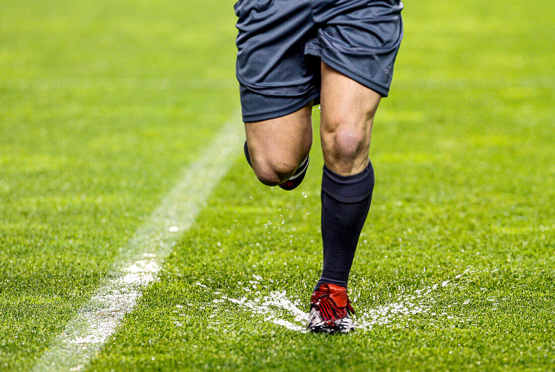 The referee navigates a flooded field during a game