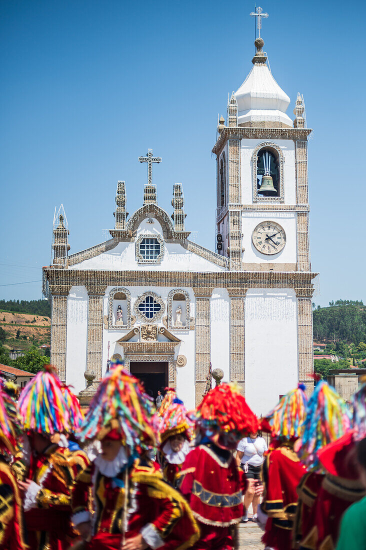 Parade passing by São João Baptista Church during The Festival of Saint John of Sobrado, also known as Bugiada and Mouriscada de Sobrado, takes place in the form of a fight between Moors and Christians , locally known as Mourisqueiros and Bugios, Sao Joao de Sobrado, Portugal