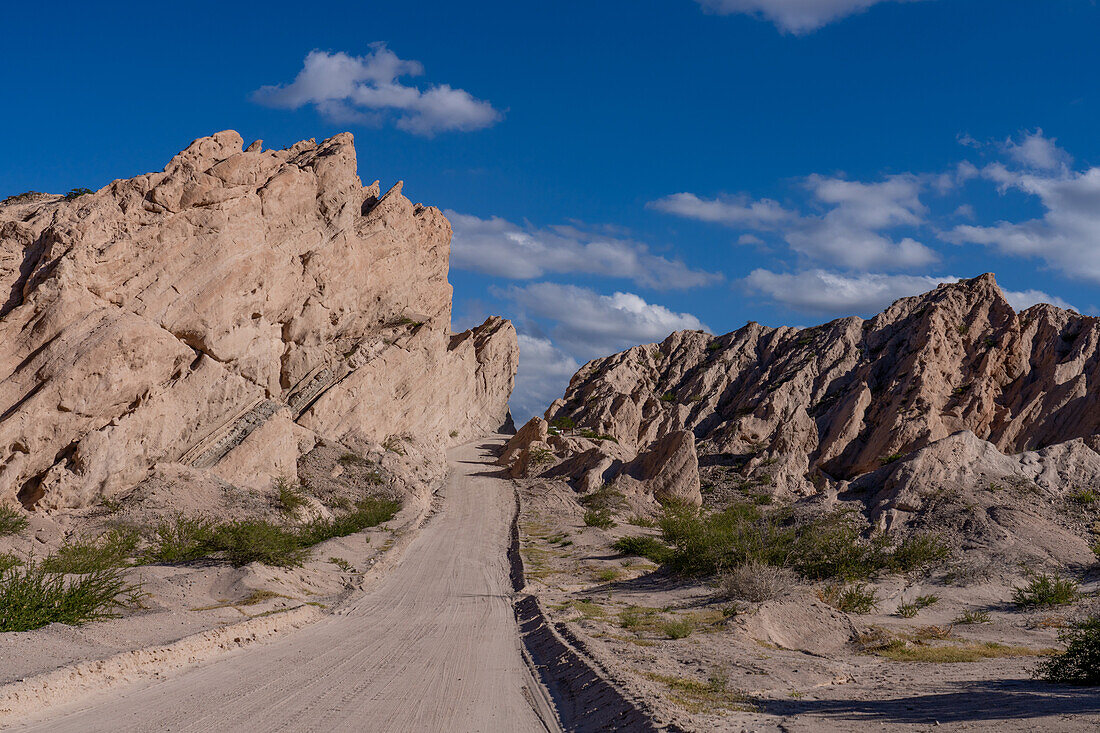 Route 40, an unpaved dirt road through the eroded landscape of the Angastaco Natural Monument in the Calchaqui Valley, Argentina.