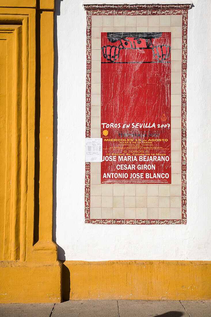 A colorful poster on the wall promotes upcoming bullfighting events at Real Maestranza in Seville, featuring dates and highlighted matadors.