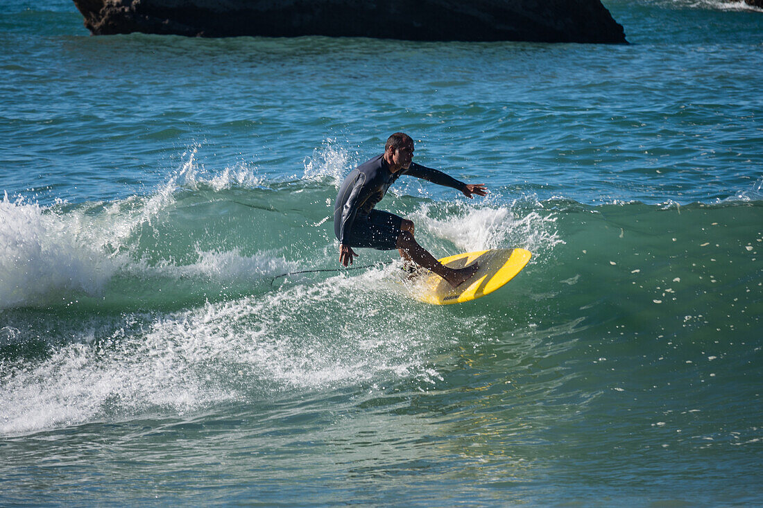 Surfers in Grande Plage beach of Biarritz, France