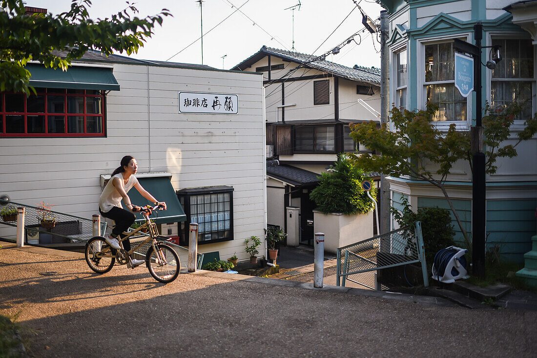 Bike riders in Philosopher's Walk in Kyoto, Japan