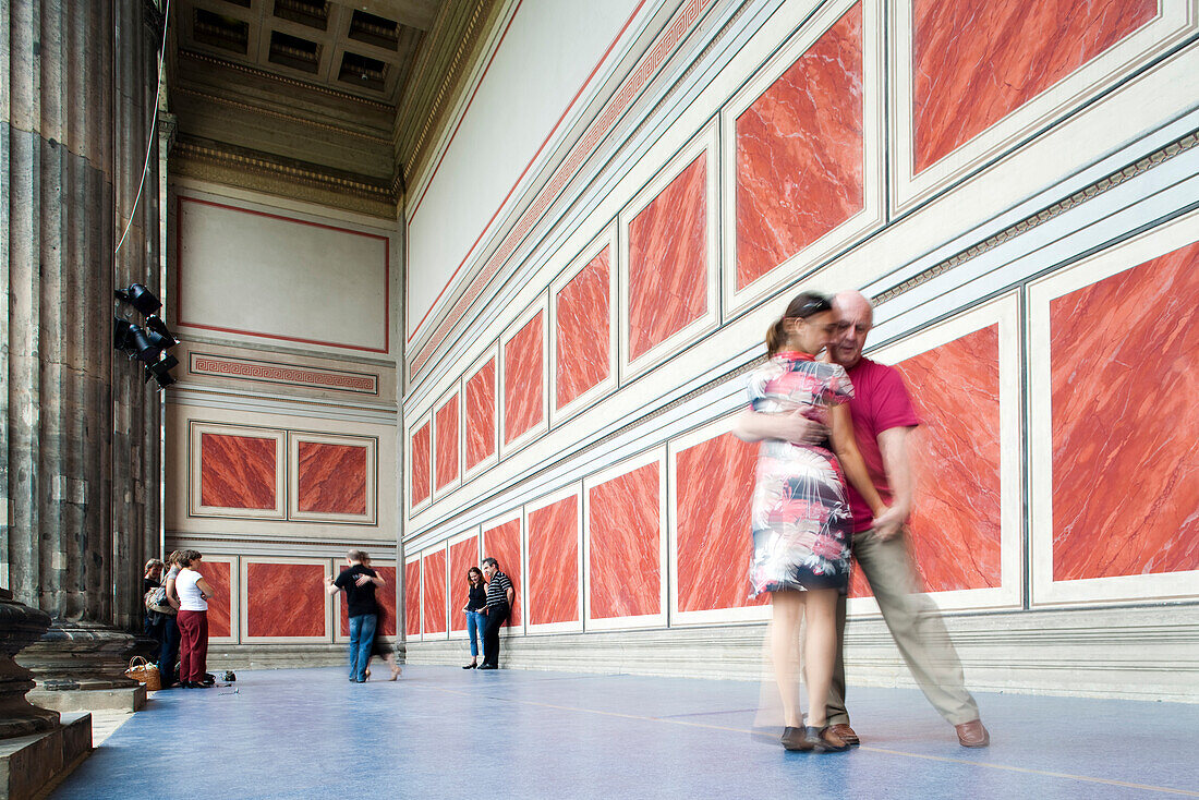 Berlin, Germany, July 24 2009, Dancers gracefully perform tango on the portico of the historic Altes Museum in Berlin, showcasing vibrant movements and connection.