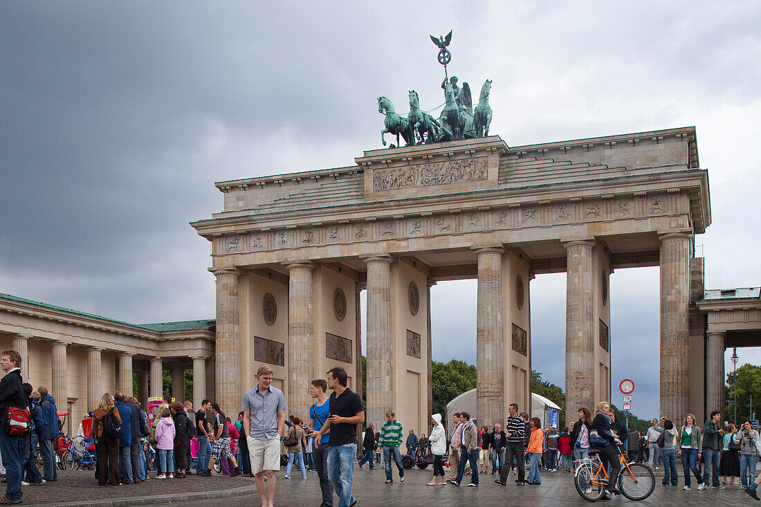 Berlin, Germany, July 24 2009, Tourists gather around the historic Brandenburg Gate in Berlin, enjoying the atmosphere and rich cultural heritage of the city.