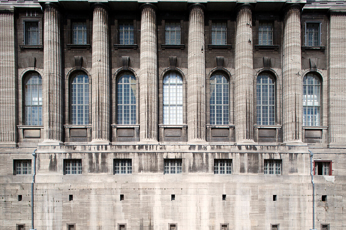 The Pergamon Museum in Berlin features a stunning architectural façade with grand columns and intricate window designs.