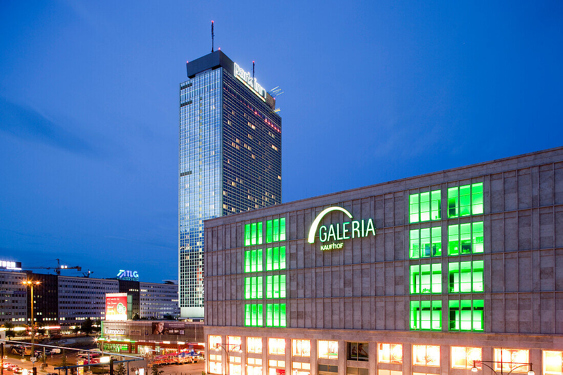 Berlin, Germany, July 21 2009, The bright lights of Galeria Kaufhof and Park Inn Hotel illuminate Alexanderplatz in Berlin during the evening.