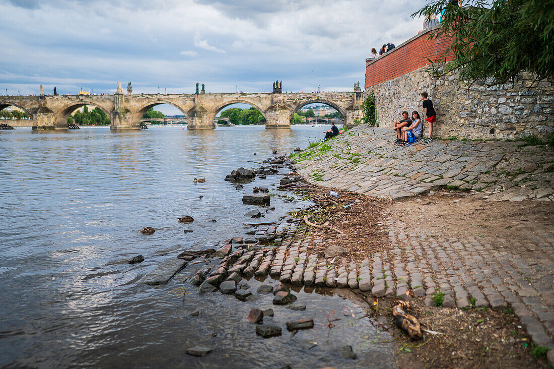 People enjoying themselves on the Vltava river bank, Prague