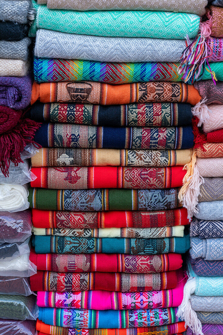 Woven goods with traditional Andean designs for sale in the open market on the square in Purmamarca, Argentina.