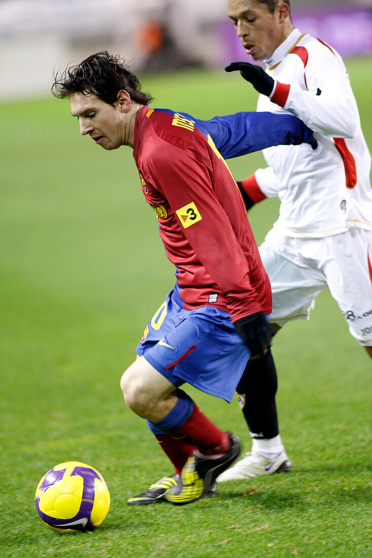 Seville, Spain, Nov 30 2008, Lionel Messi skillfully navigates the pitch while being challenged by Adriano in a La Liga match at Sánchez Pizjuán Stadium.