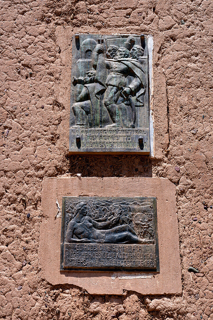 Bronze plaque on the adobe bell tower of the Santa Barbara church in Humahuaca in the Quebrada de Humahuaca, Argentina.