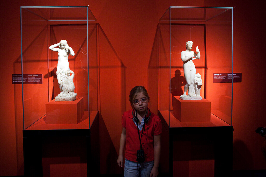 Berlin, Germany, July 24 2009, A child stands between two Aphrodite statues in the vibrant Pergamon Museum, experiencing art and culture in Berlin.