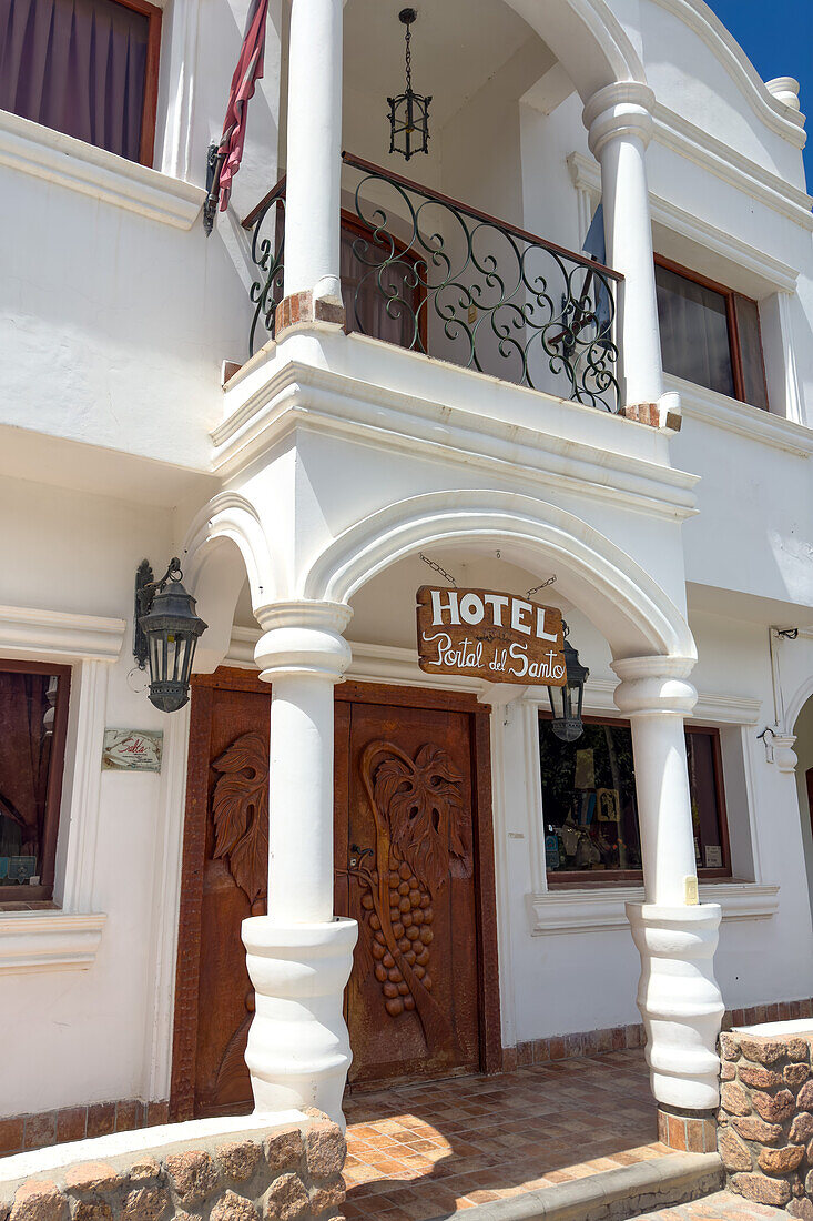 The facade and entrance of the Portal del Santo Hotel in Cafayate, Argentina.