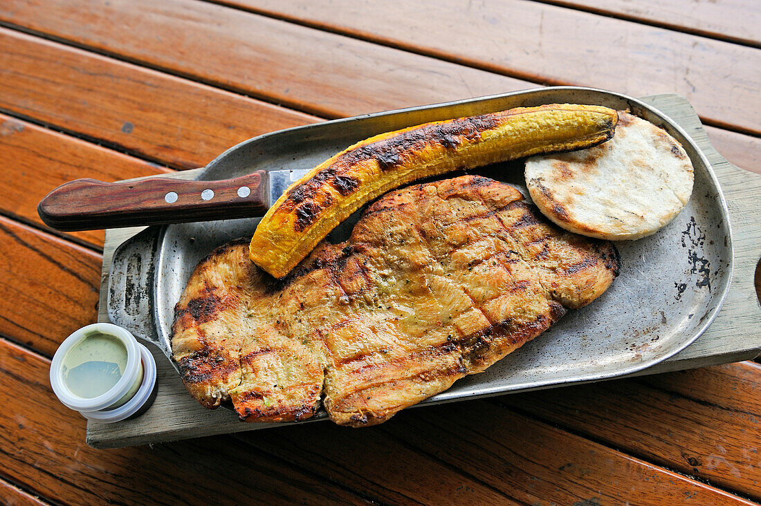 Grilled breast of chicken and fried plantain served in a restaurant at Cocora Valley, around Solento, department of Quindio, Colombia, South America