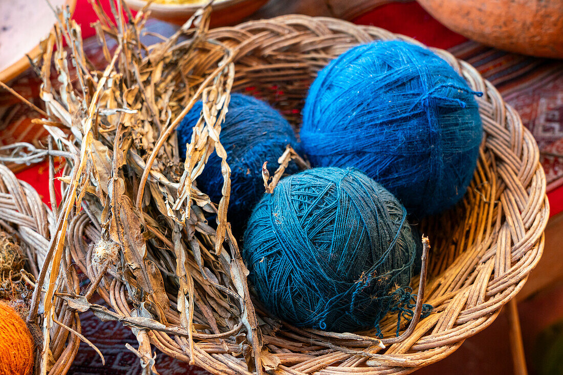 Blue balls of wool and dried plant as natural dye, Chinchero, Sacred Valley, Urubamba Province, Cusco (Cuzco) Region, Peru, South America