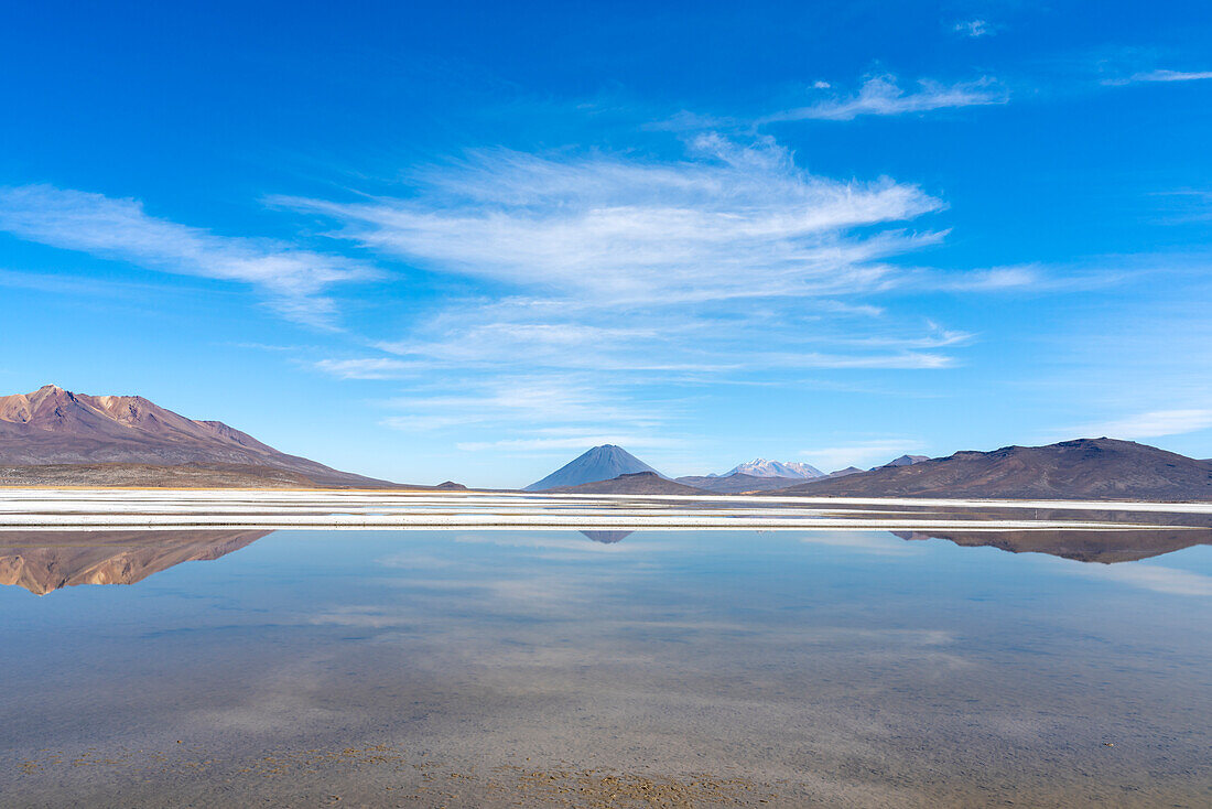 Reflection pool on salt flats and distant views of El Misti and Chachani volcanoes, Salinas y Aguada Blanca National Reserve, Arequipa Province, Arequipa Region, Peru, South America