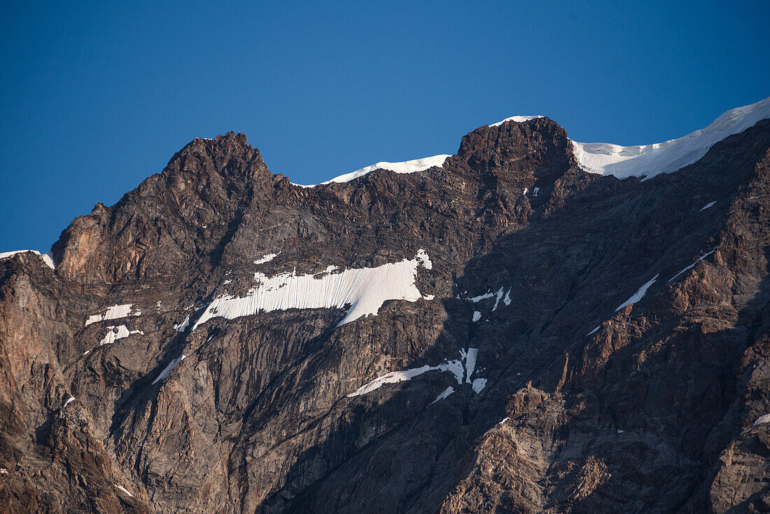 Close up of the rugged summit of Dufourspitze, Monte Rosa, against a blue sky, Nature Park Valsesia and the Alta Val Strona, Piedmont, Italian Alps, Italy, Europe