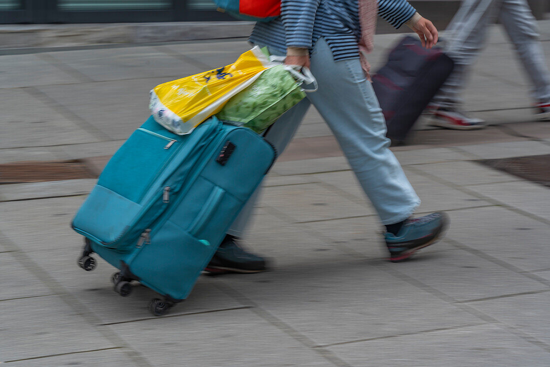 View of people with roller suitcases heading for Central Station, Oslo, Norway, Scandinavia, Europe