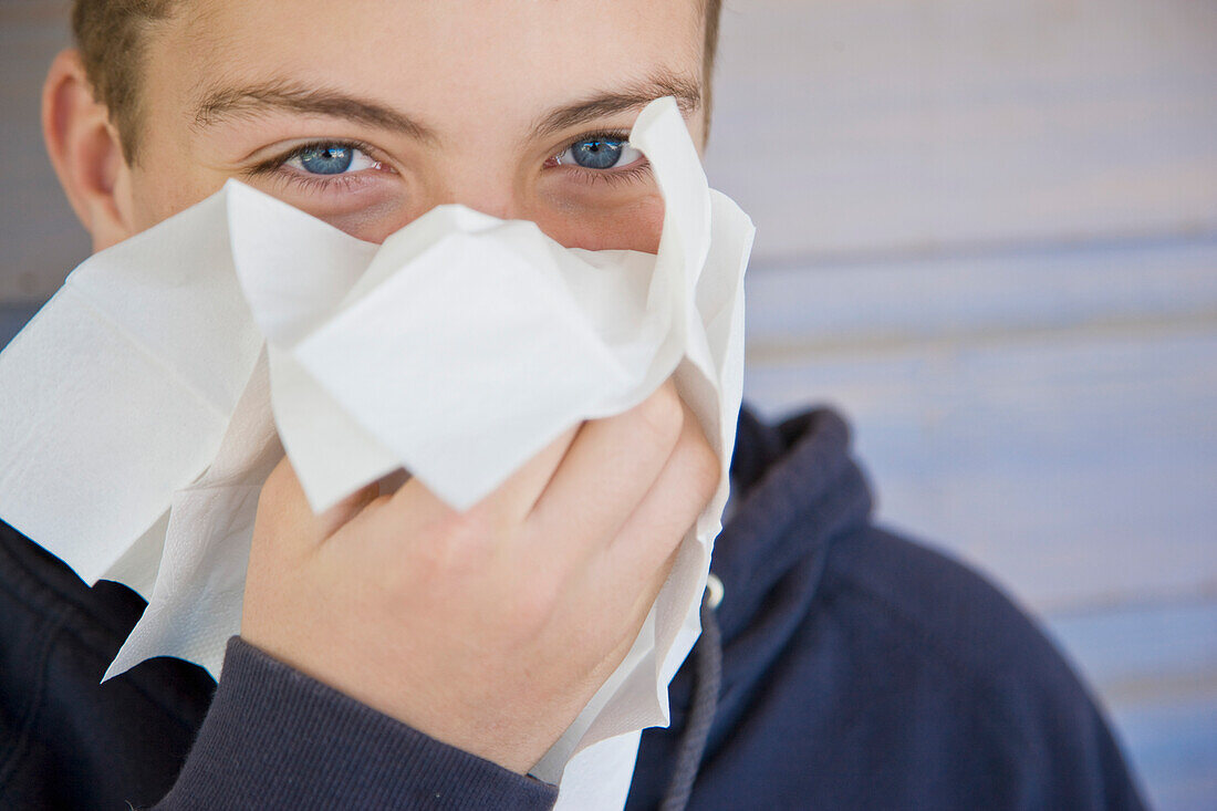 Boy blowing his nose