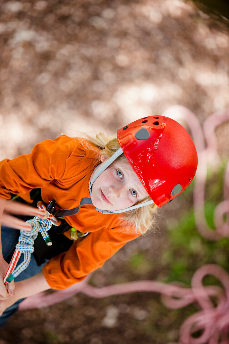 Young girl dangling from a rope - high angle