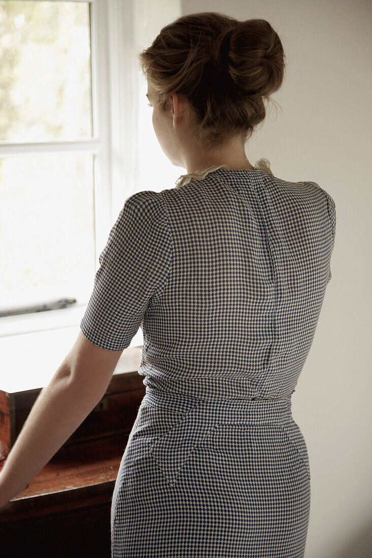 Back View of Woman Looking Out of Window