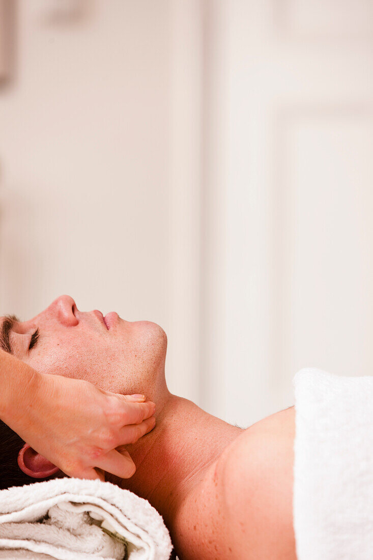 Man receiving a head and face massage