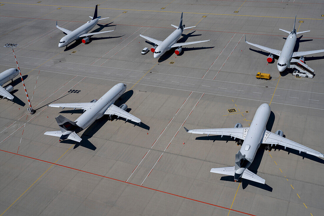 High angle view airplanes parked on sunny airport tarmac