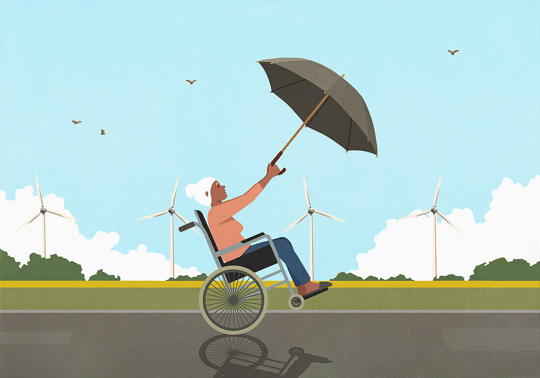 Wind blowing senior woman in wheelchair with umbrella along wind turbines