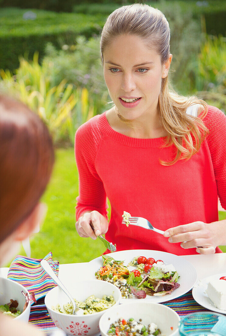 Woman Having Lunch in Garden with Friend