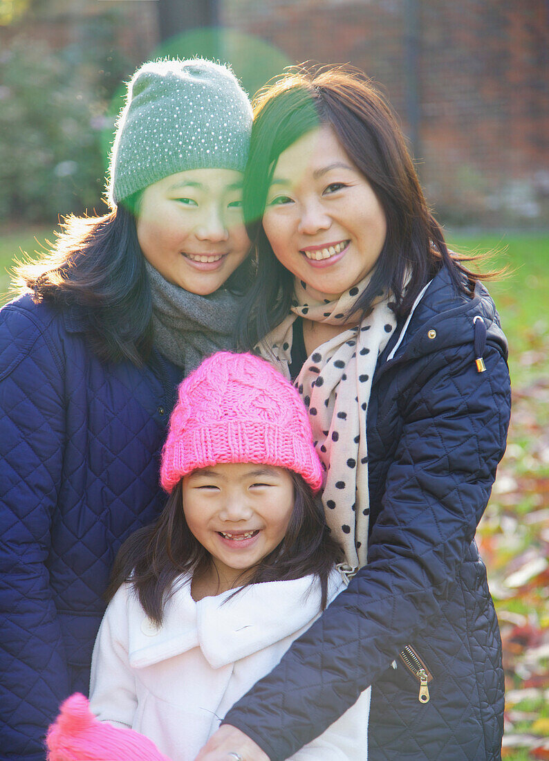 Mother and her Daughters Smiling Outdoors