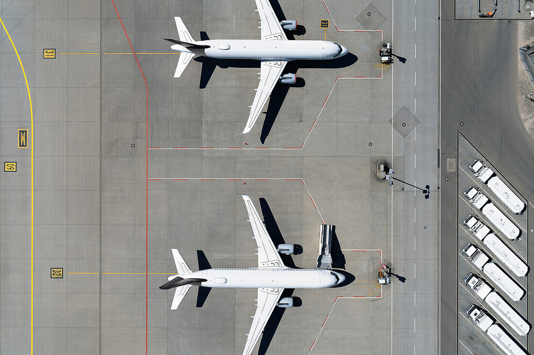 View from above airplanes parked on sunny airport tarmac