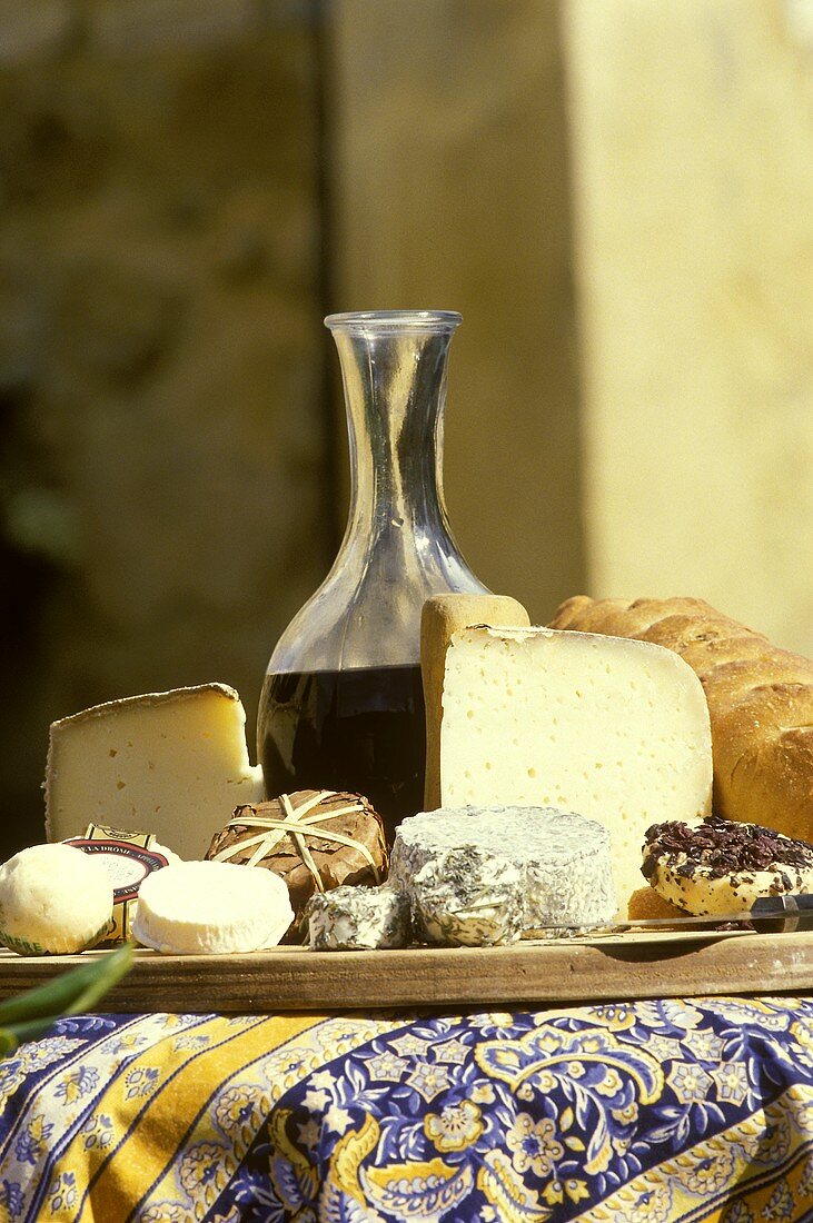 French goat's cheeses and red wine on table