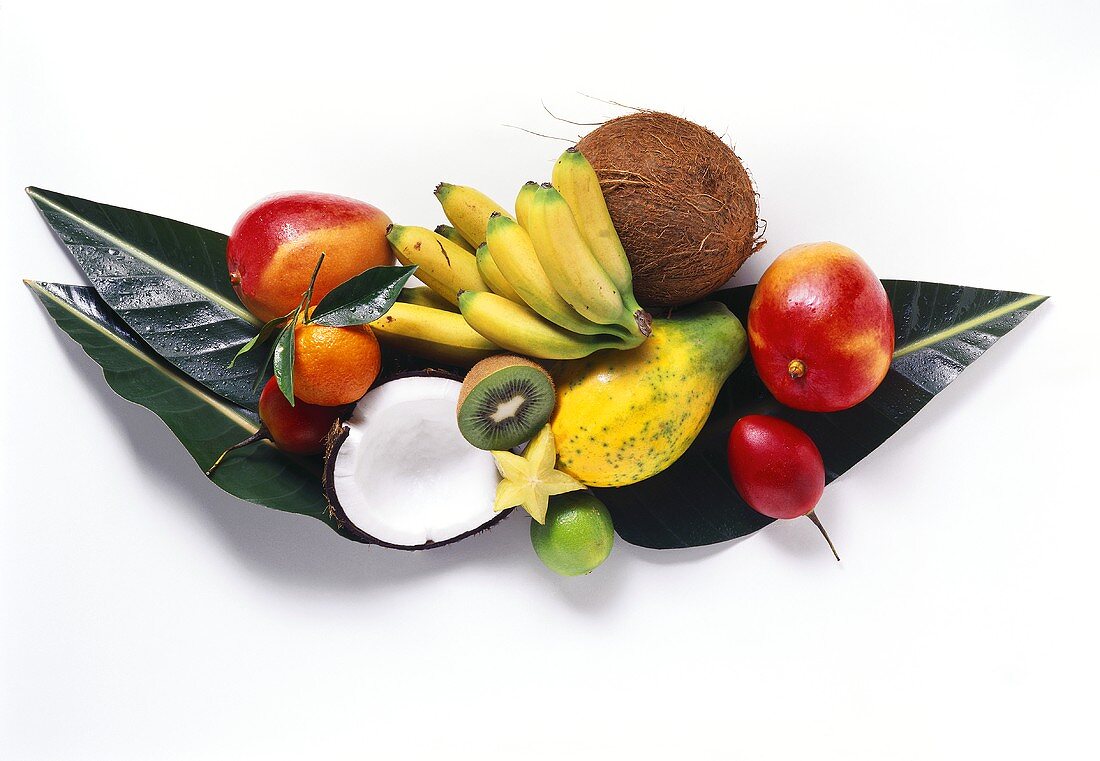 Exotic fruits and coconut on banana leaves