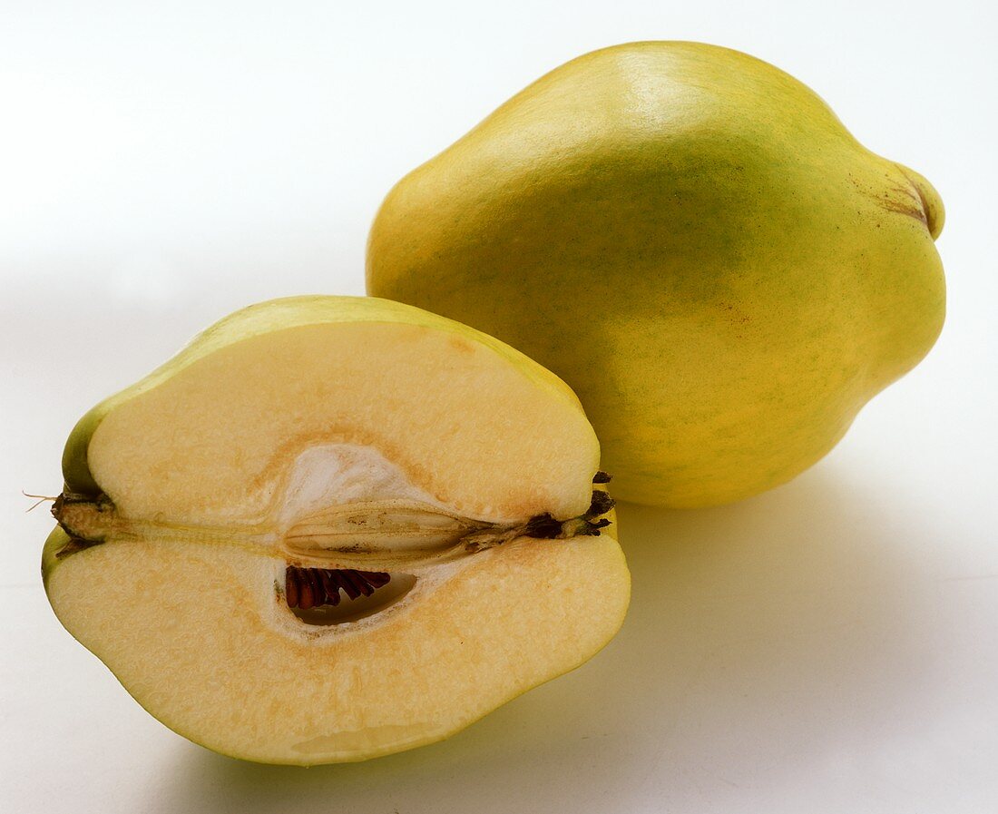 Quince and quince half on white background