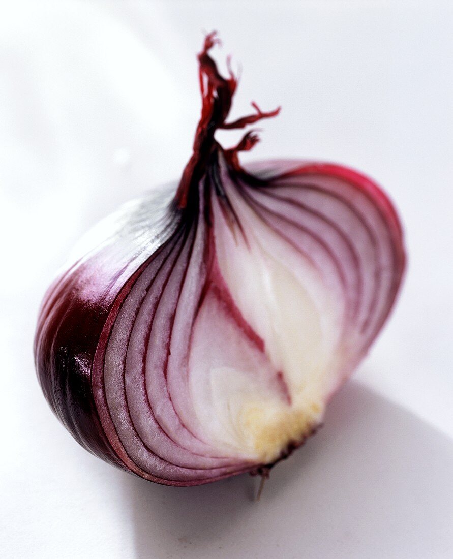 Red onion, halved, on light background