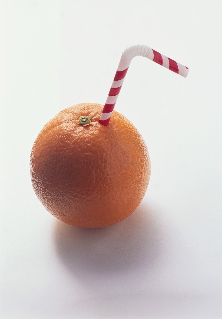 Drinking straw sticking out of an orange