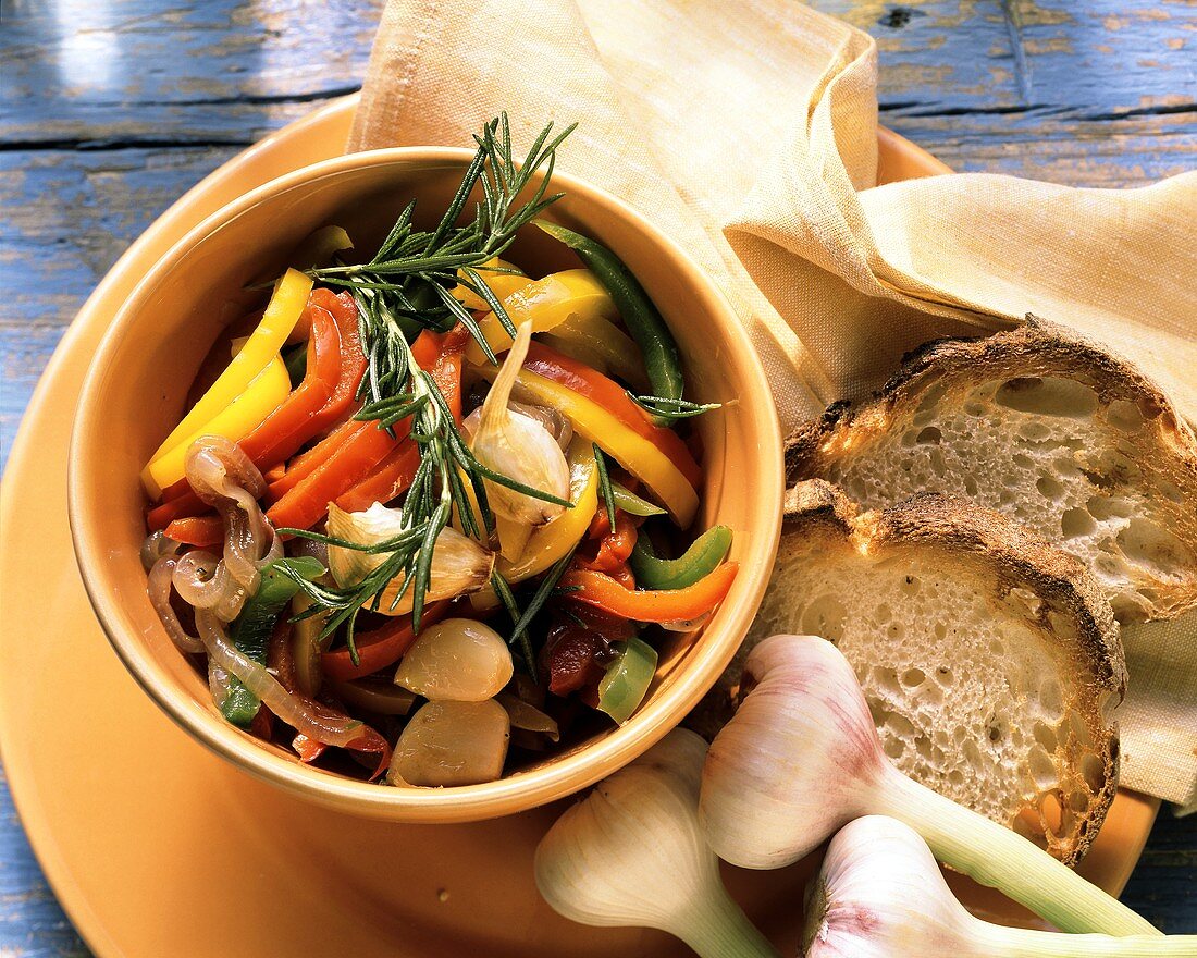 Cooked peppers with garlic and rosemary in bowl