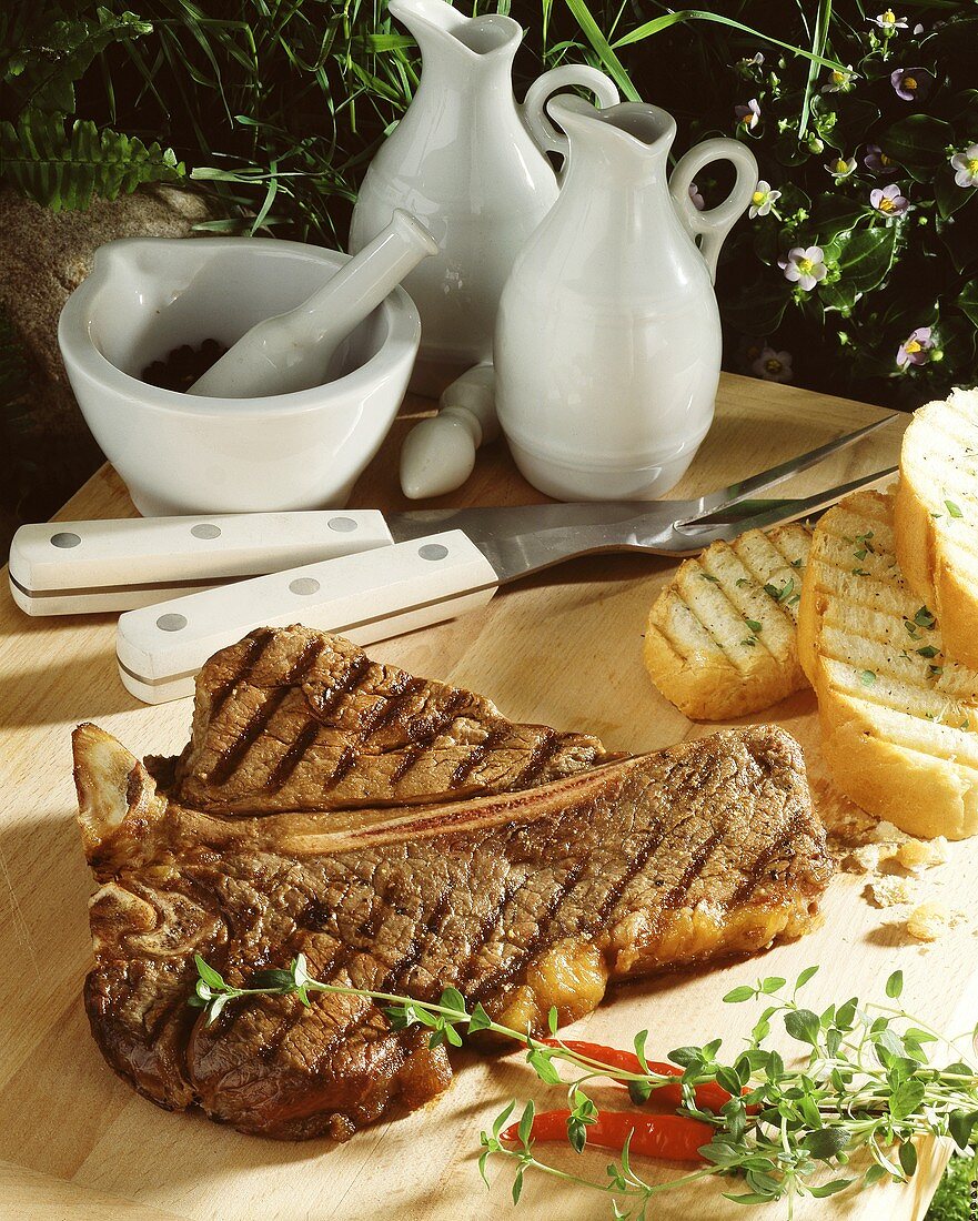 Grilled T-bone steak on wooden platter