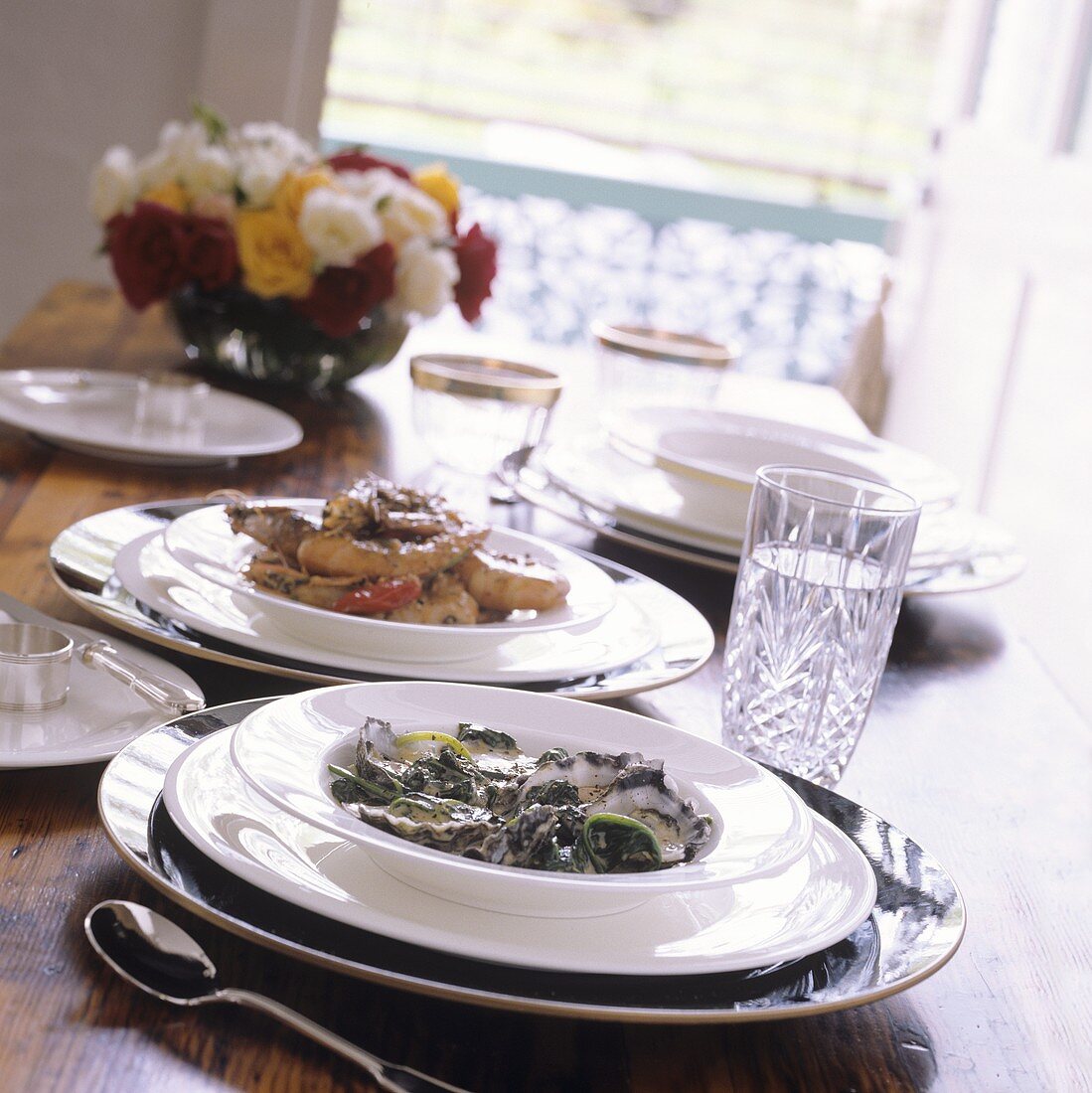 Oysters with spinach in cream sauce, behind fried shrimps